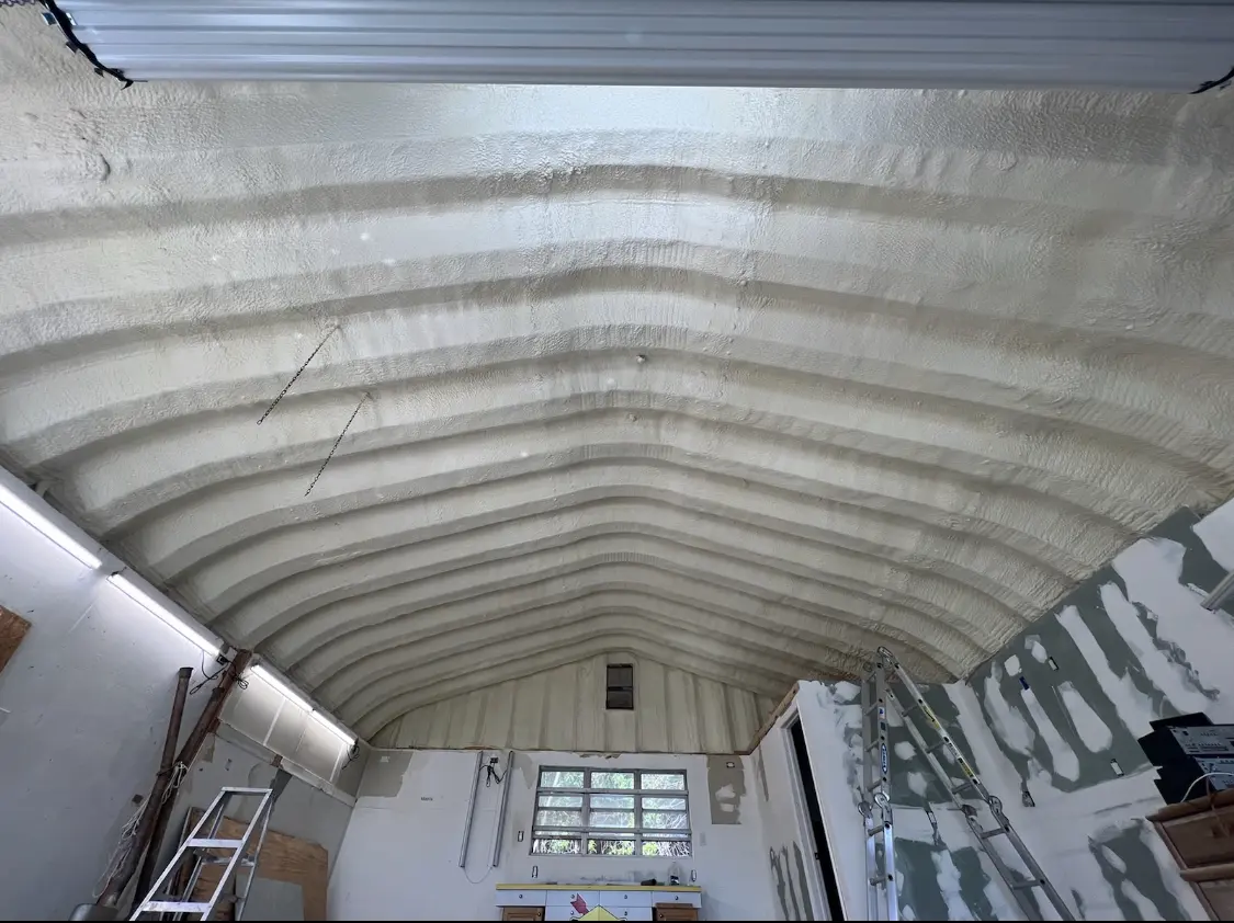 Spray polyurethane foam applied to the underside of a metal roof deck in Reserve